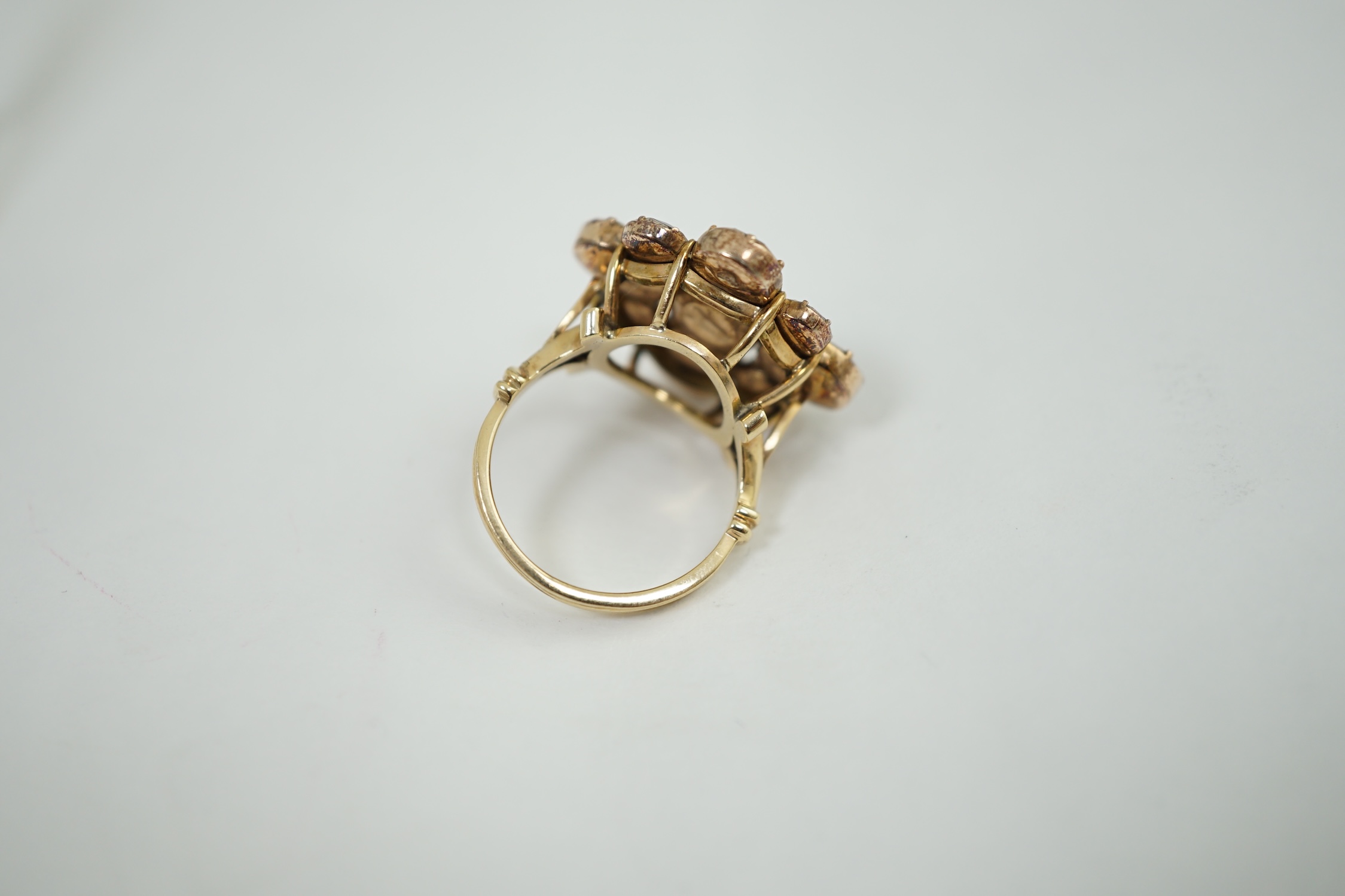 A late Victorian gold and nine stone garnet cluster set dress ring, of flower head design, set with round and oval cut stones, size L, gross weight 6.4 grams. Condition - poor to fair